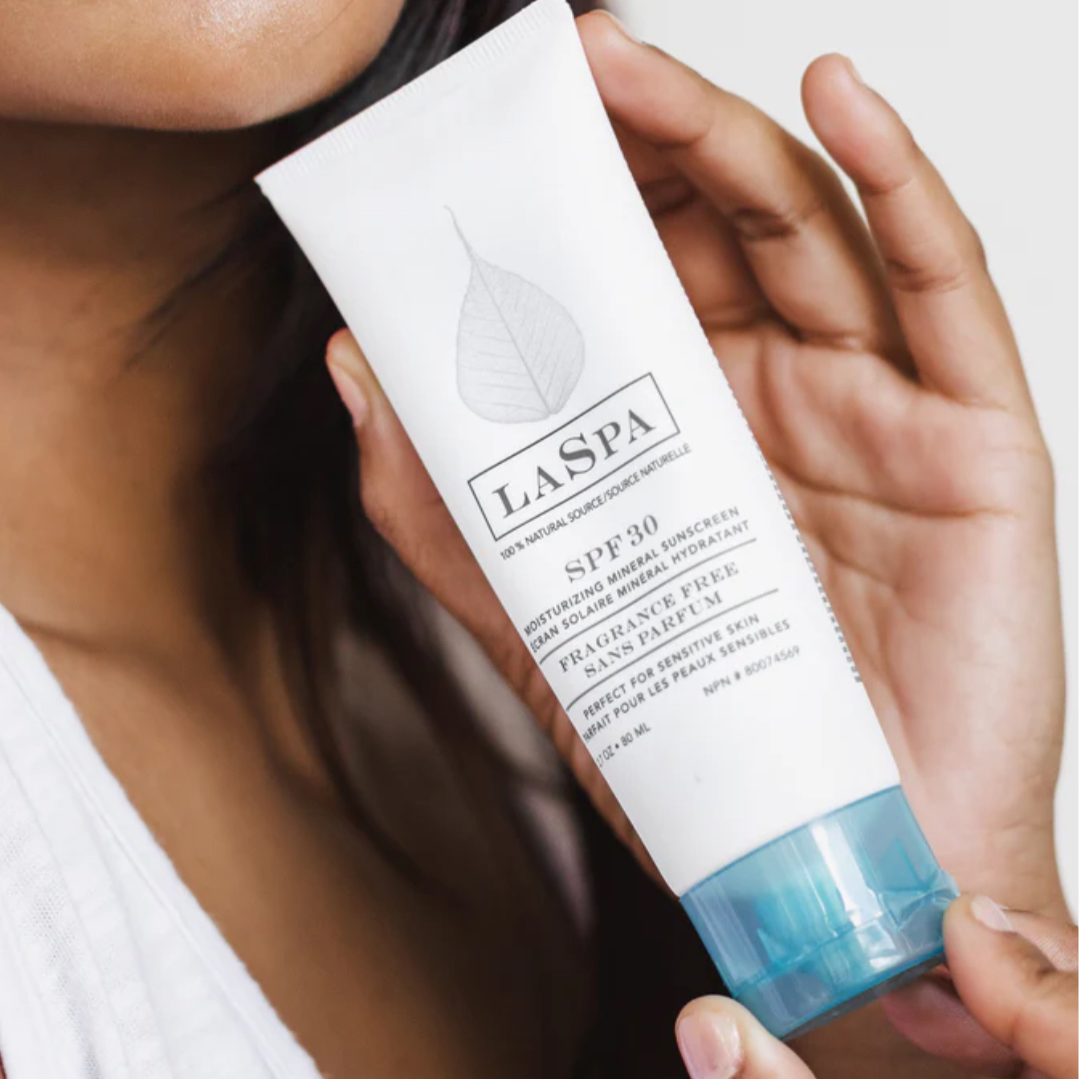 Woman’s hands holding LASPA sunscreen