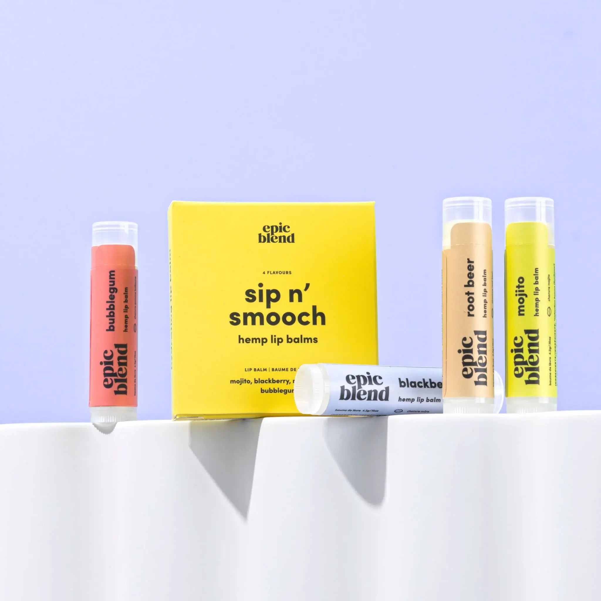 Collection of Epic Blend hemp lip balms on a white surface with a light purple background