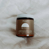 Jar of Genesis Magnesium tallow on a textured white background