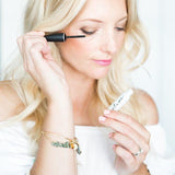woman applying Plume eye lash serum