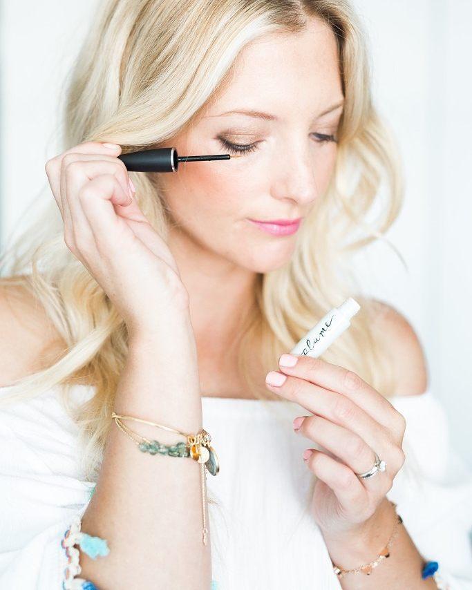woman applying Plume eye lash serum
