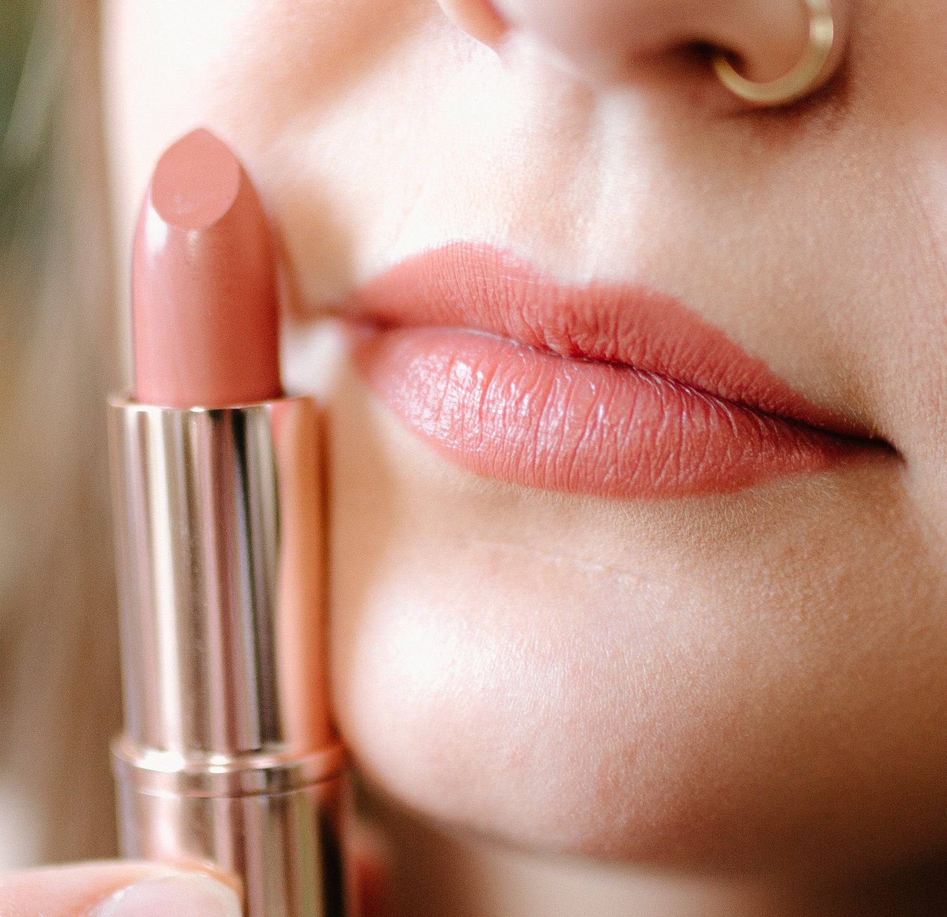 Pure Anada Lipstick with rose gold casing on a white background