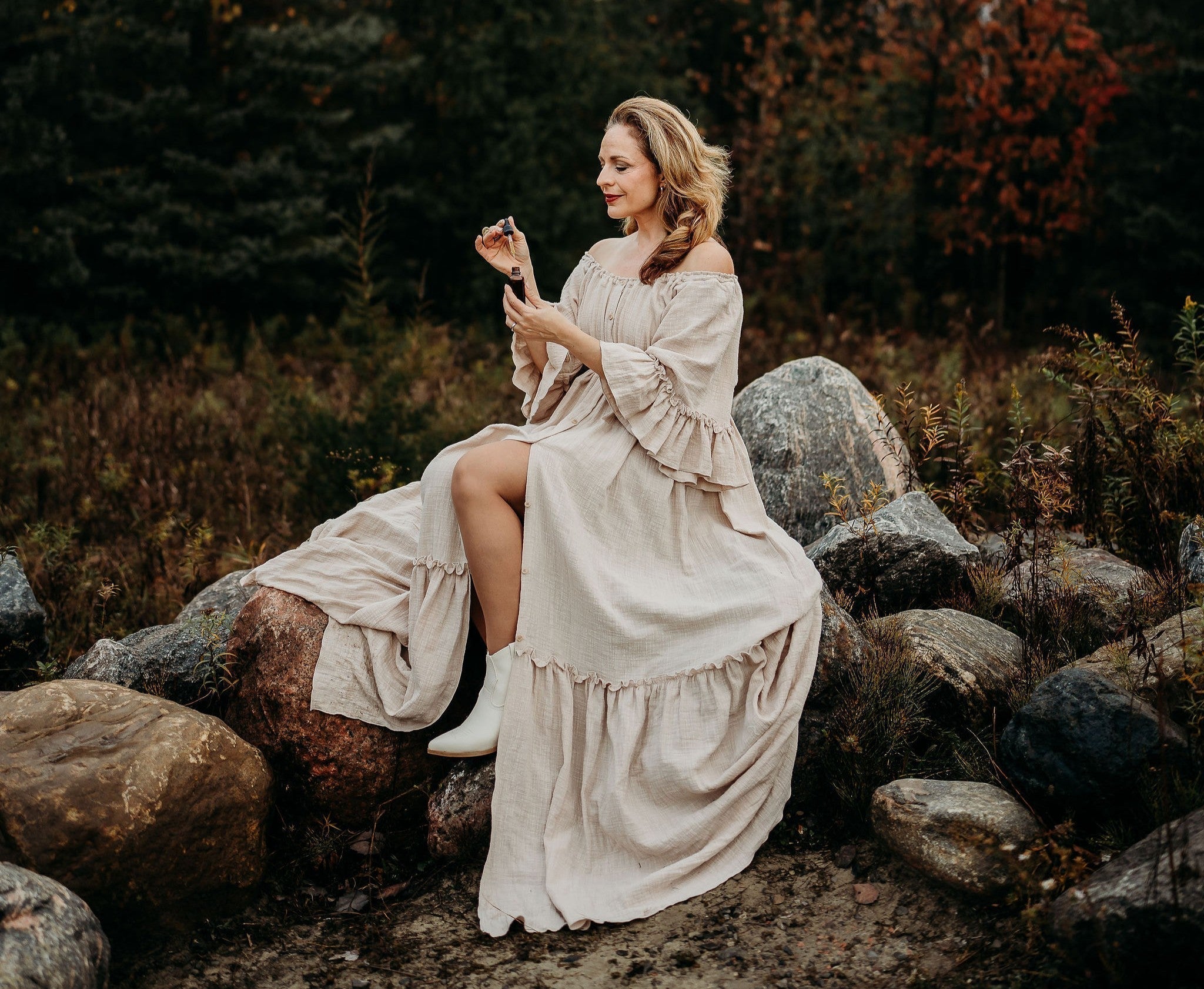 Maria Velve sitting on rock holding serum