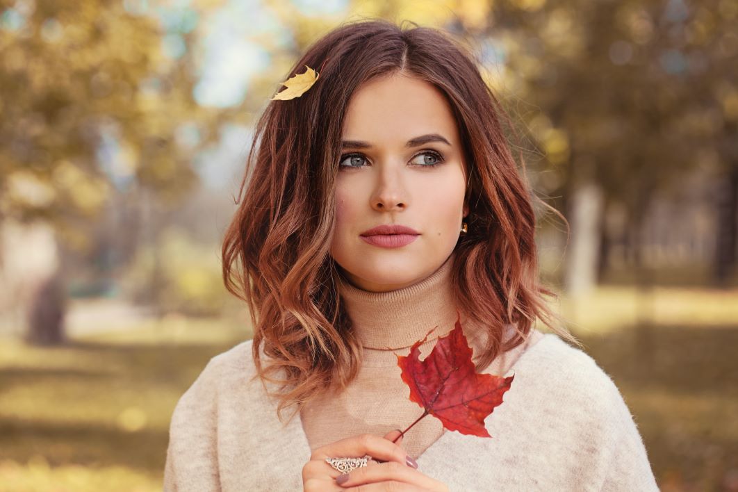 woman with fall leaves