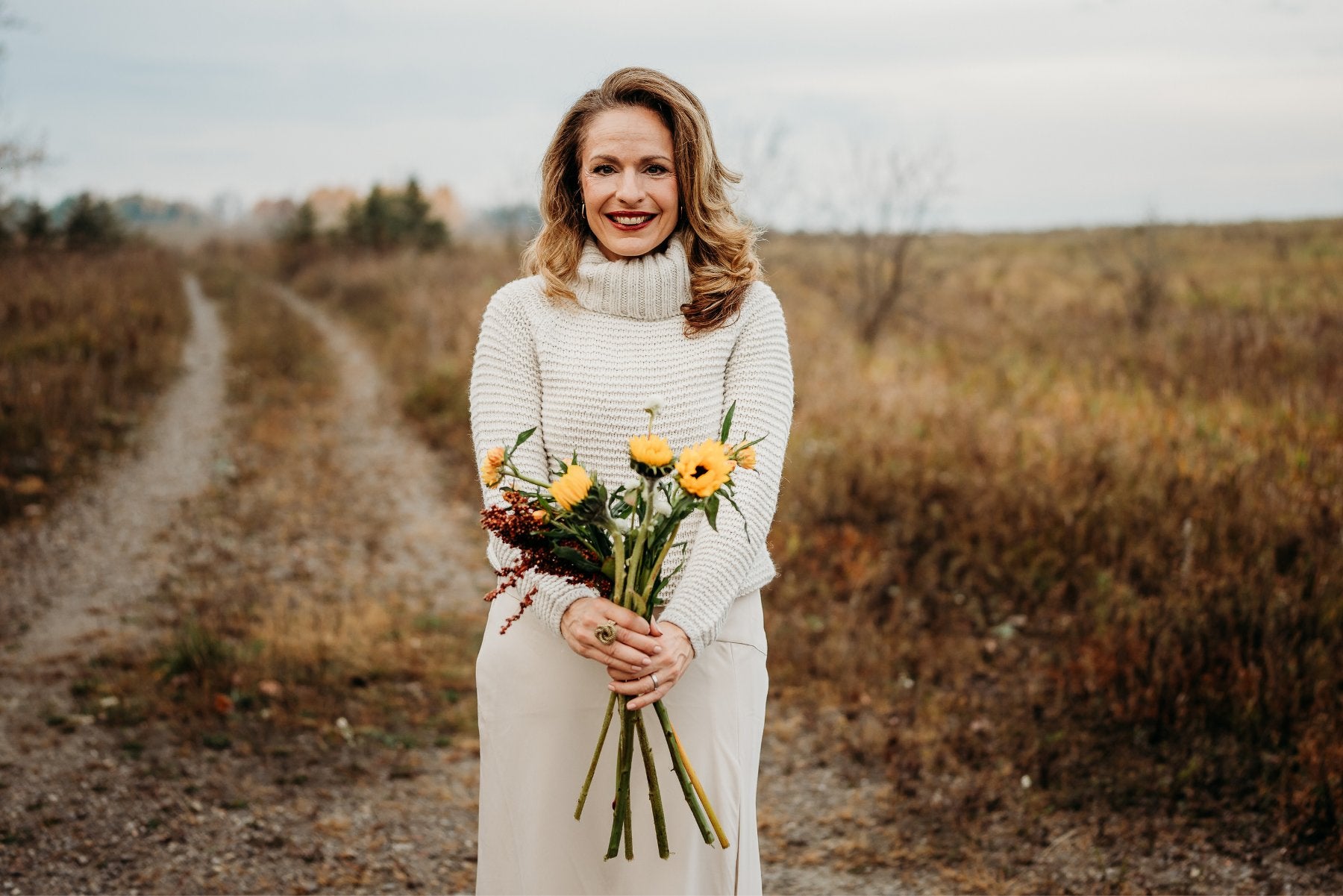 Maria Velve holding sunflowers