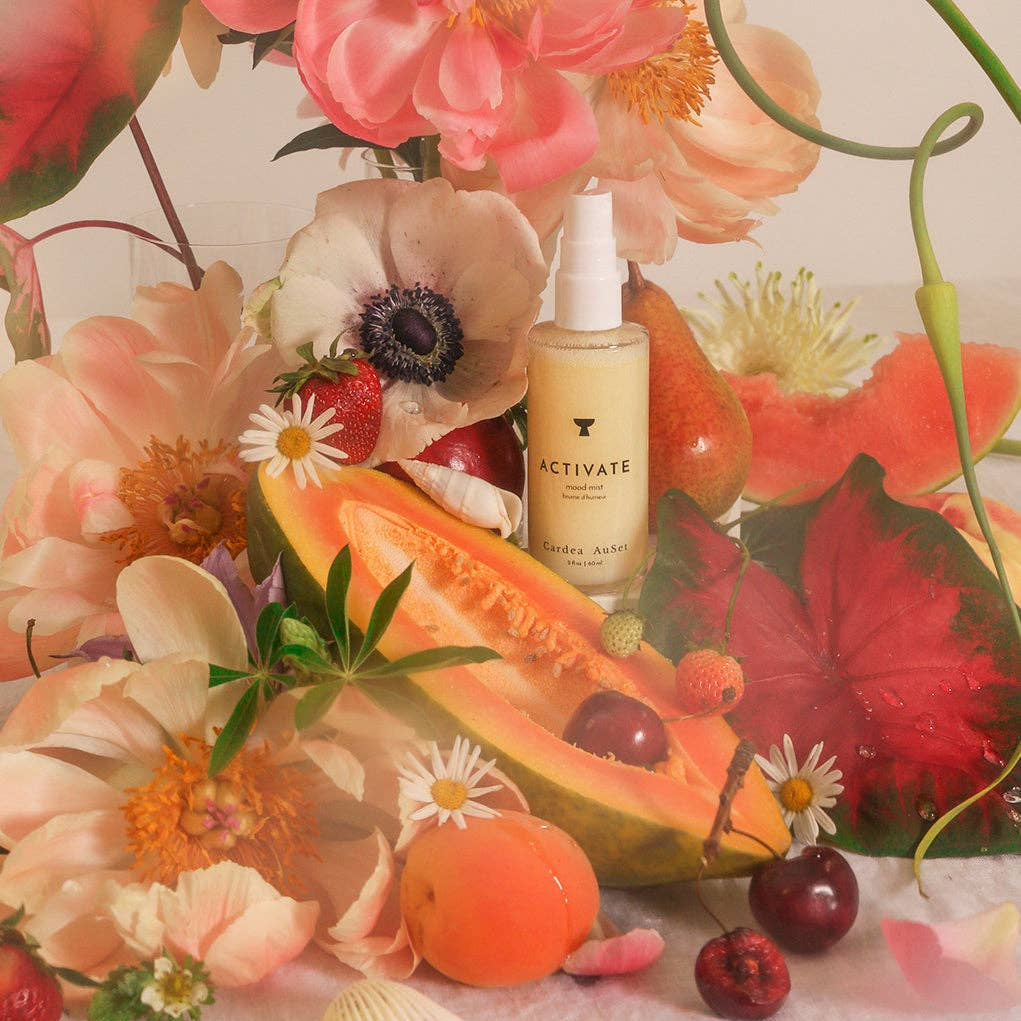 Activate Mood Mist with fruits and flowers on a textured surface