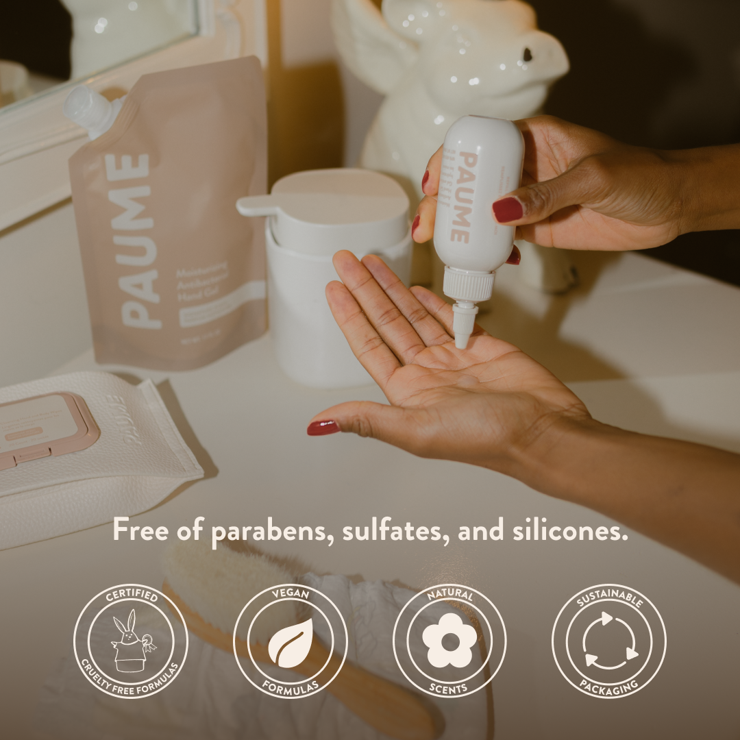 Person applying PAUME skincare product to hand with branded items in the background