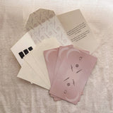 Set of pink Homebound Tarot cards with icons on a textured surface