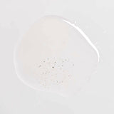 Om Organics body oil Clear oil-like substance with small particulates on a light gray background