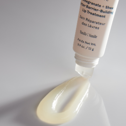 Tube of Three Ships Soft Serve lip treatment with a small amount of product on a white background