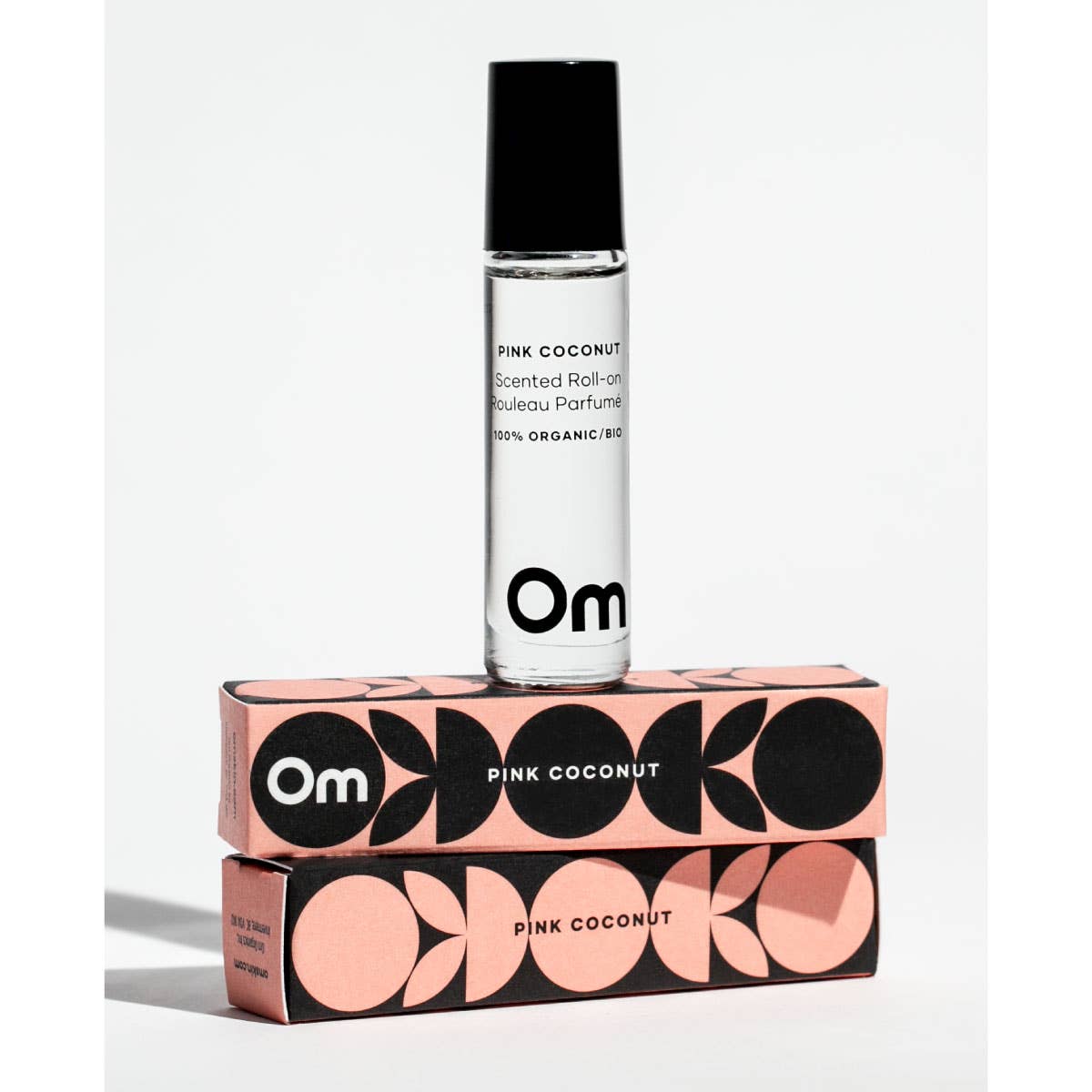 Om Pink Coconut scented rollerball perfume with packaging on a white background