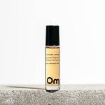 Om Organics Roll-on perfume bottle labeled 'Om' on a light background
