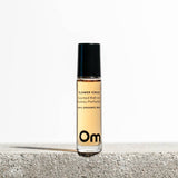 Om Organics Roll-on perfume bottle labeled 'Om' on a light background