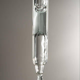 Glass dropper with a drop of Graydon Supermoon serum on a gray background