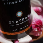 Graydon skincare bottle with floral background