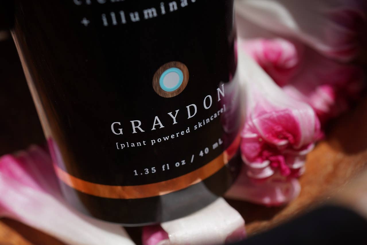 Graydon skincare bottle with floral background