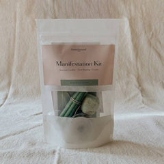 Manifestation Kit packaging with candles and stones.