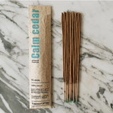 A Essence of Life CALM CEDAR incense sticks with several sticks visible outside the package.