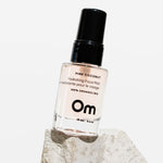 OM Organics Pink coconut hydrating face mist bottle with black cap on a white background