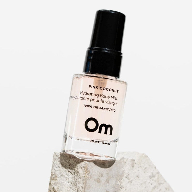 OM Organics Pink coconut hydrating face mist bottle with black cap on a white background