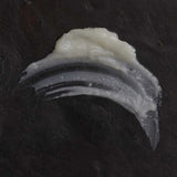 Close-up of OM Organics cleansing balm on a dark background