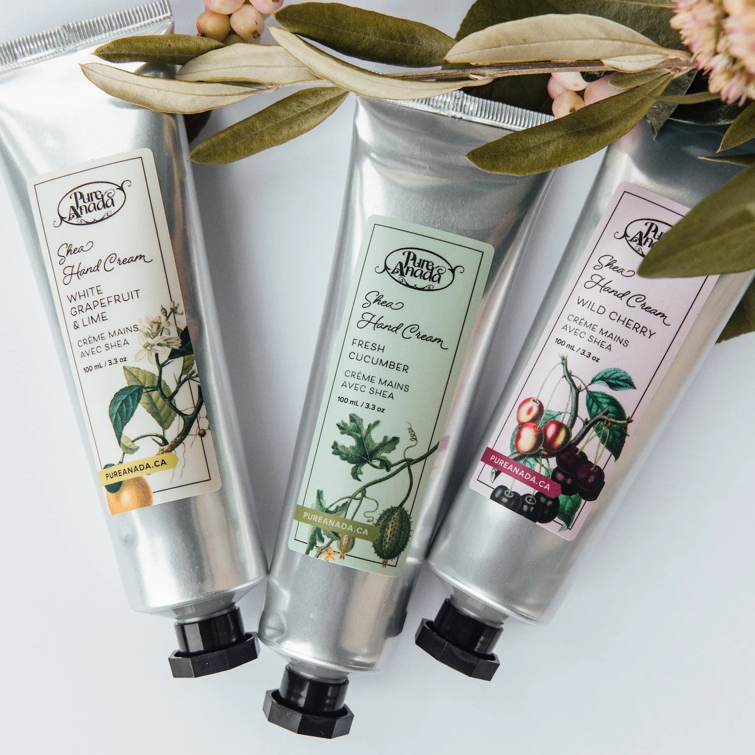 Three tubes of Pure Anada hand cream with labels on a white background