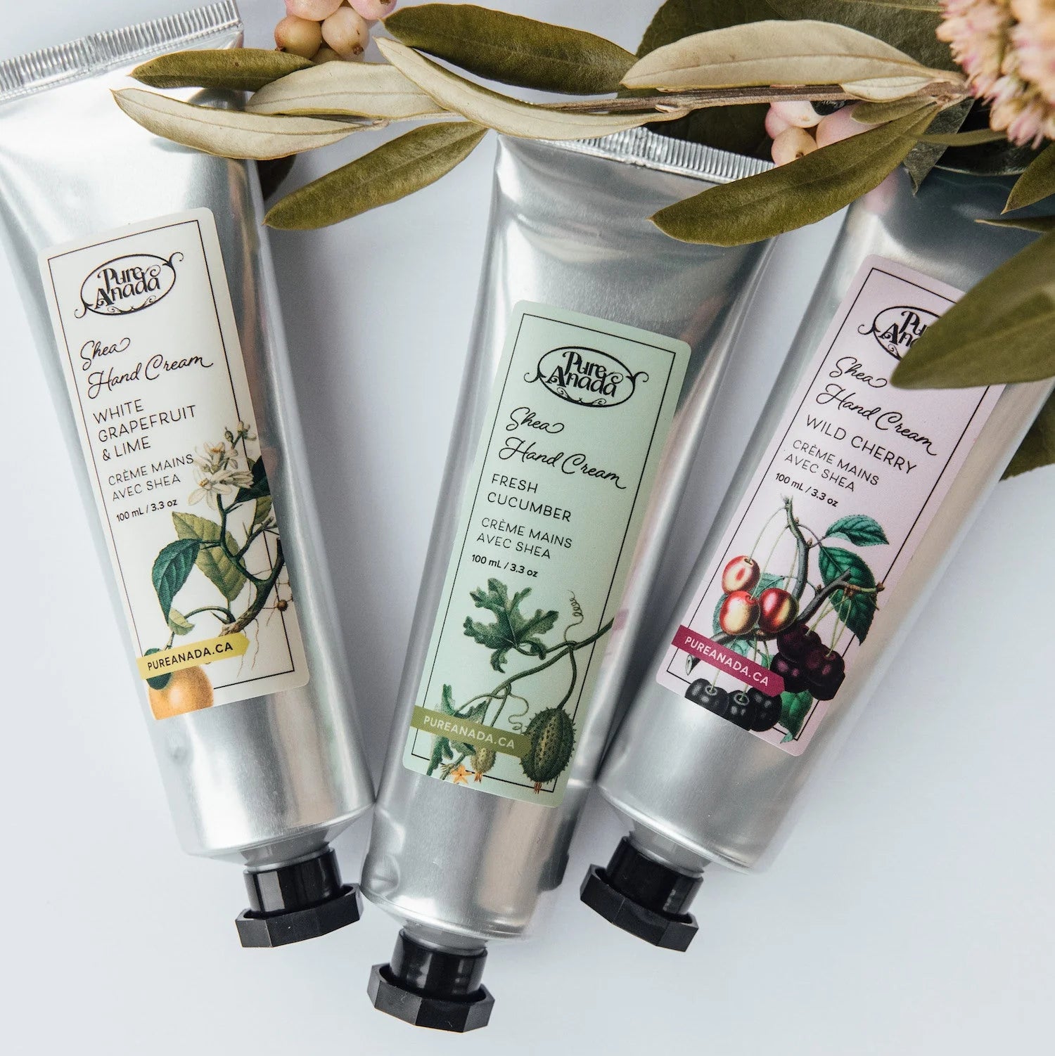 Three tubes of Pure Anada hand cream with labels on a white background