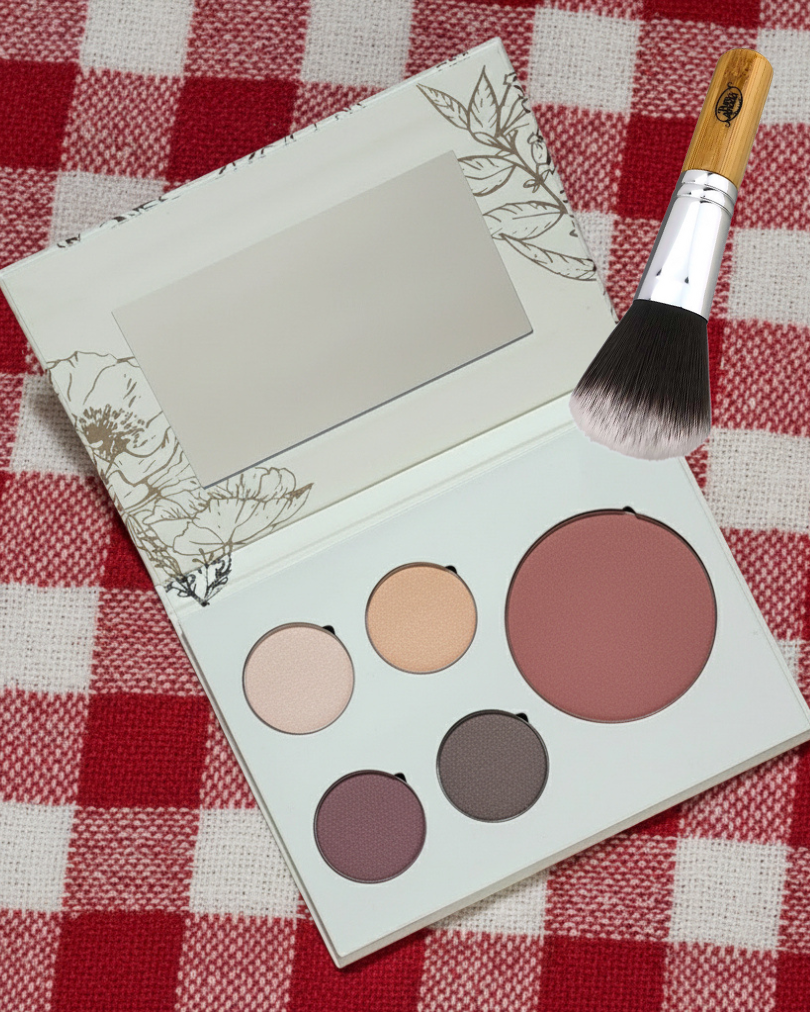 Pure Anada Makeup palette with four colors and a brush on a red and white checkered tablecloth