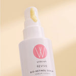 Wildcraft serum bottle with pink logo and 'wildcraft' text on a beige background