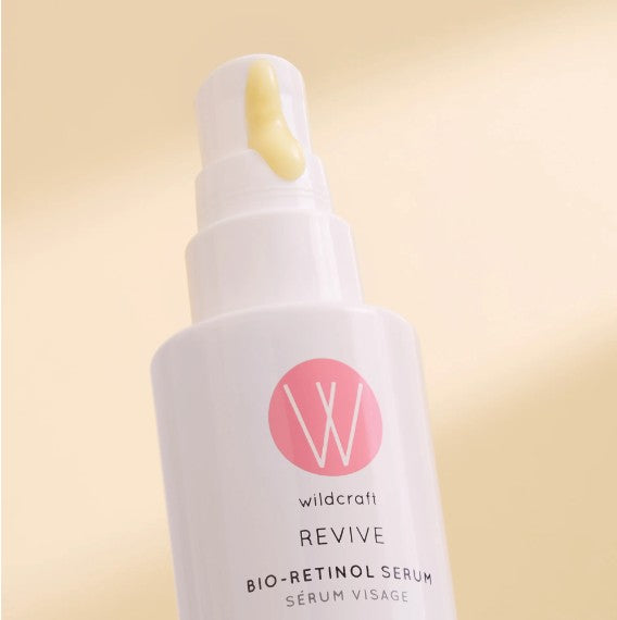 Wildcraft serum bottle with pink logo and 'wildcraft' text on a beige background