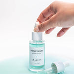 Hand holding a bottle of 'supermoon' serum by Graydon 