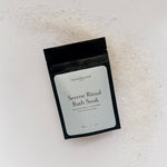 Serene Ritual Bath Soak packaging on a textured surface