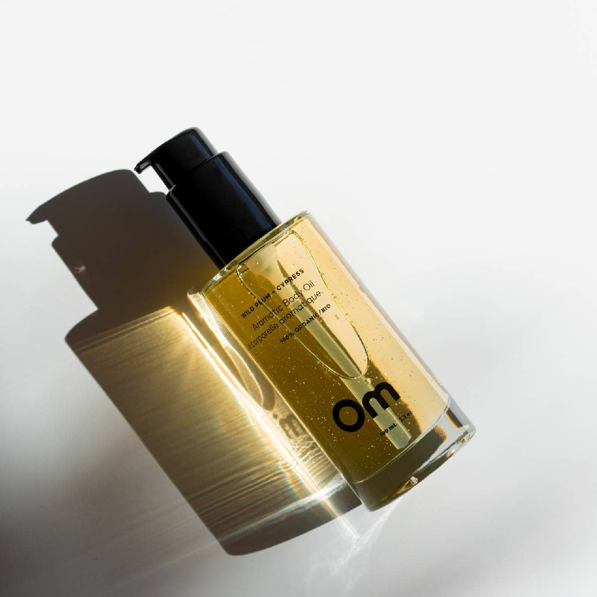 Glass bottle with black cap of Om Organics body oil 