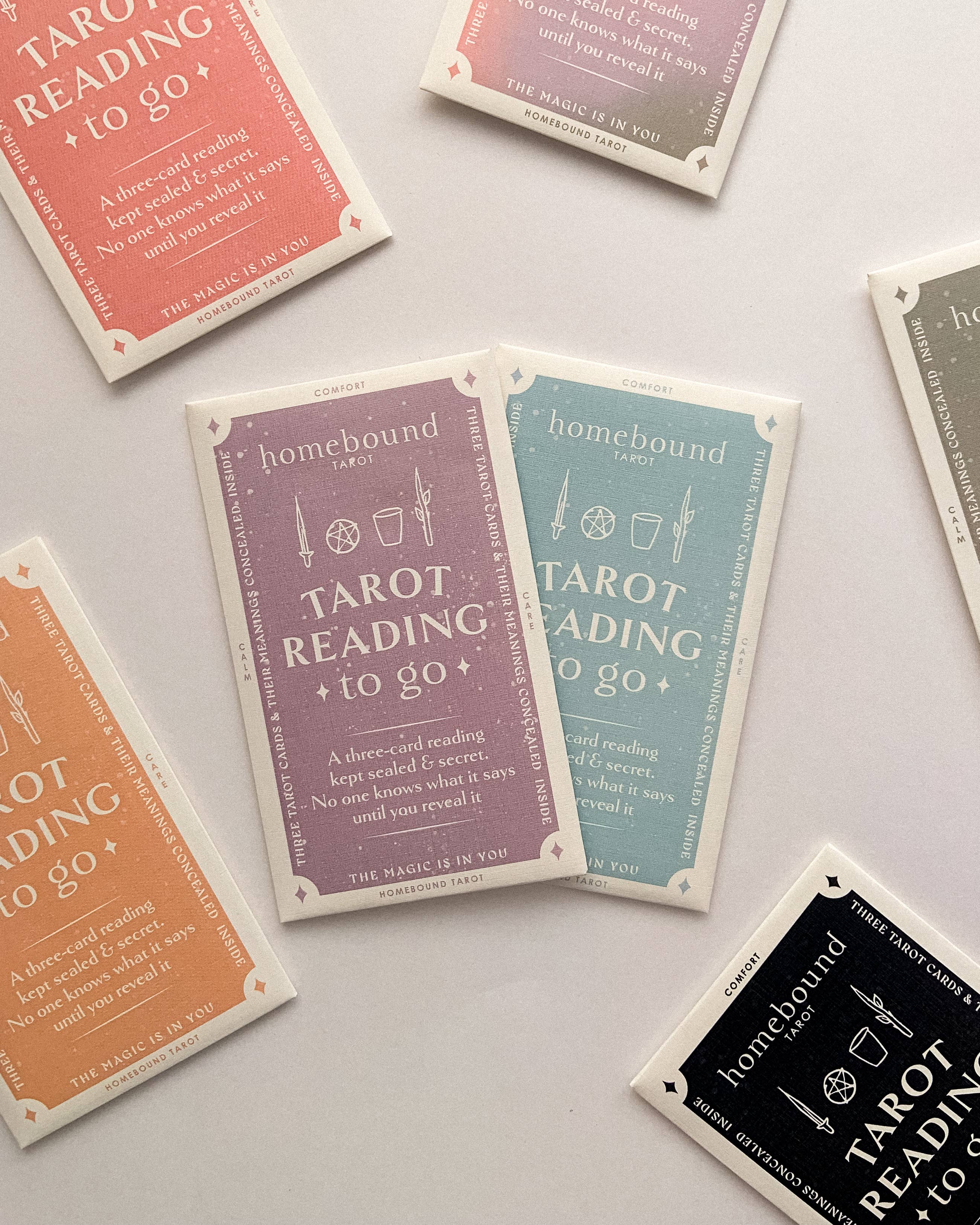 Collection of Homebound tarot cards with colorful designs and text on a light gray background