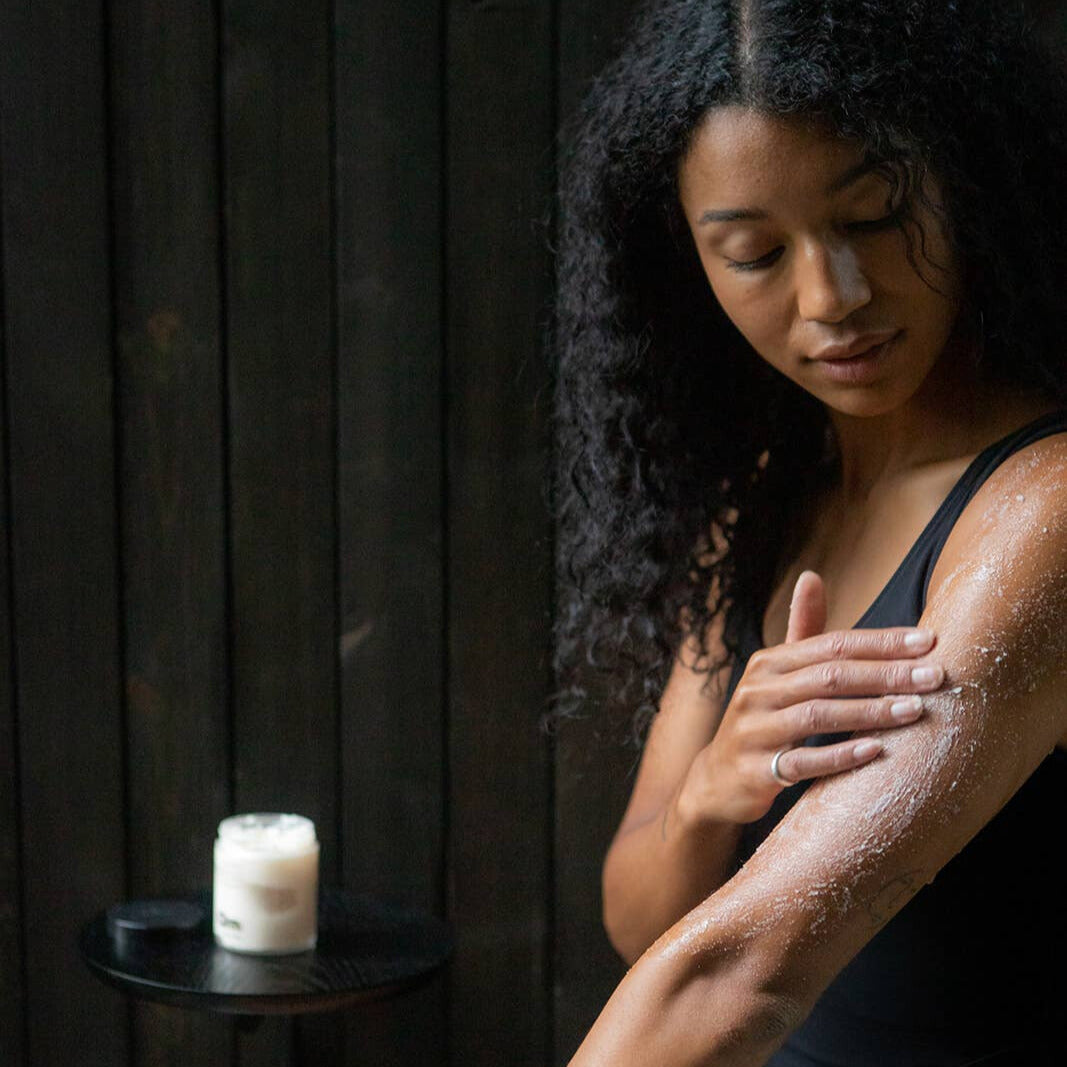 The Bathologist Hydrate skincare products on a white surface with a plant in the foreground