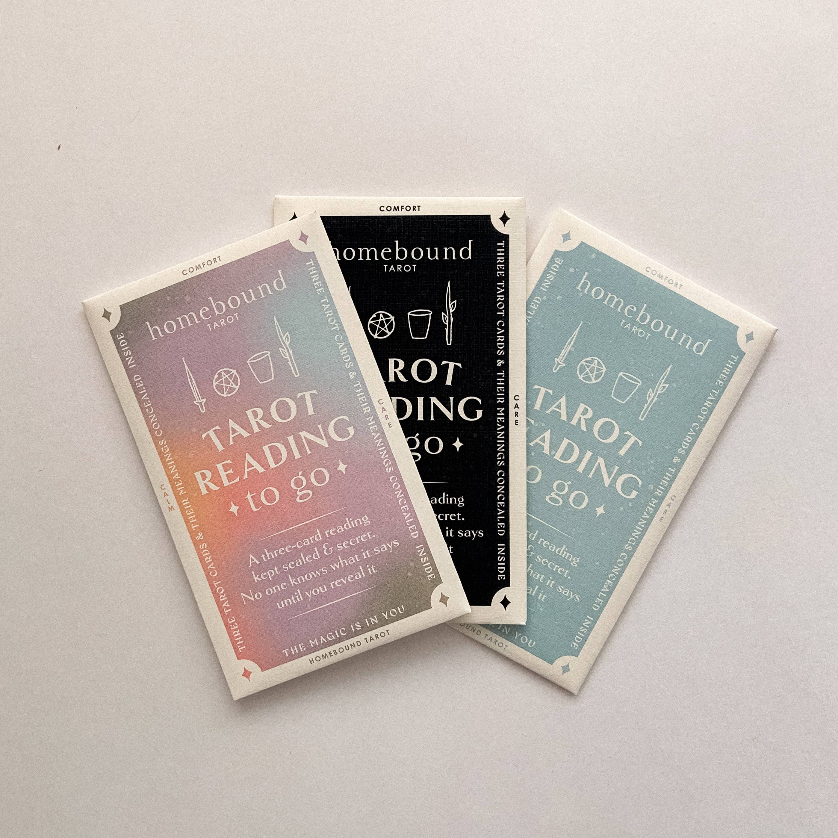 Three tarot cards from Homebound Tarot on a light gray background