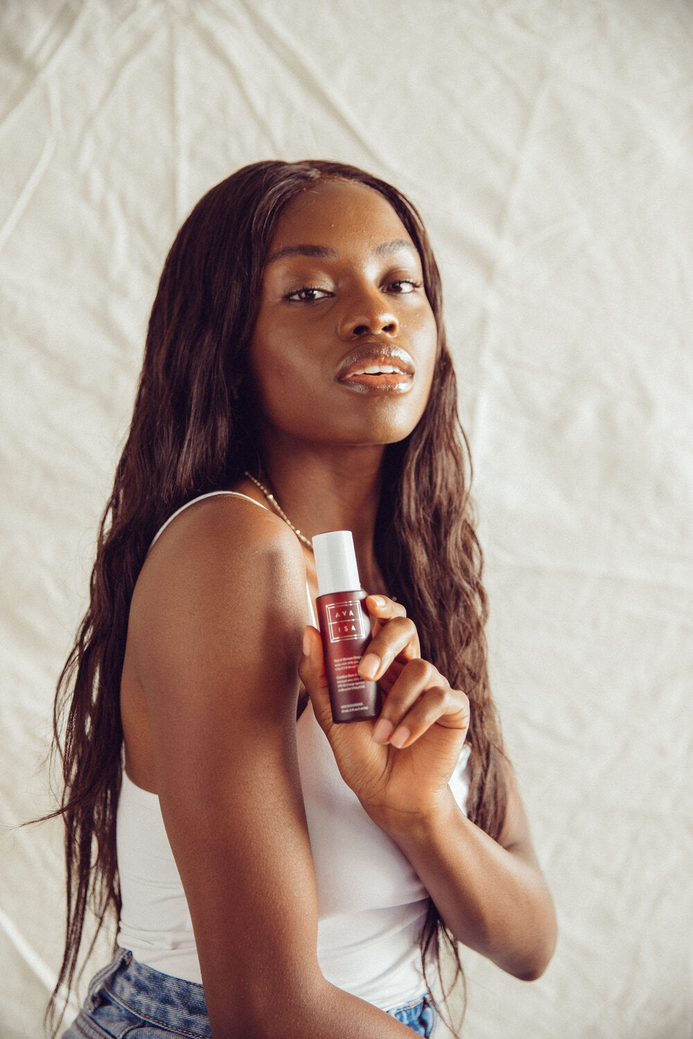 Beautiful woman with Ava Isa Sun to Serum drops