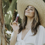 Young woman with Ava Isa Sun to Serum Drops