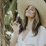 Young woman with Ava Isa Sun to Serum Drops